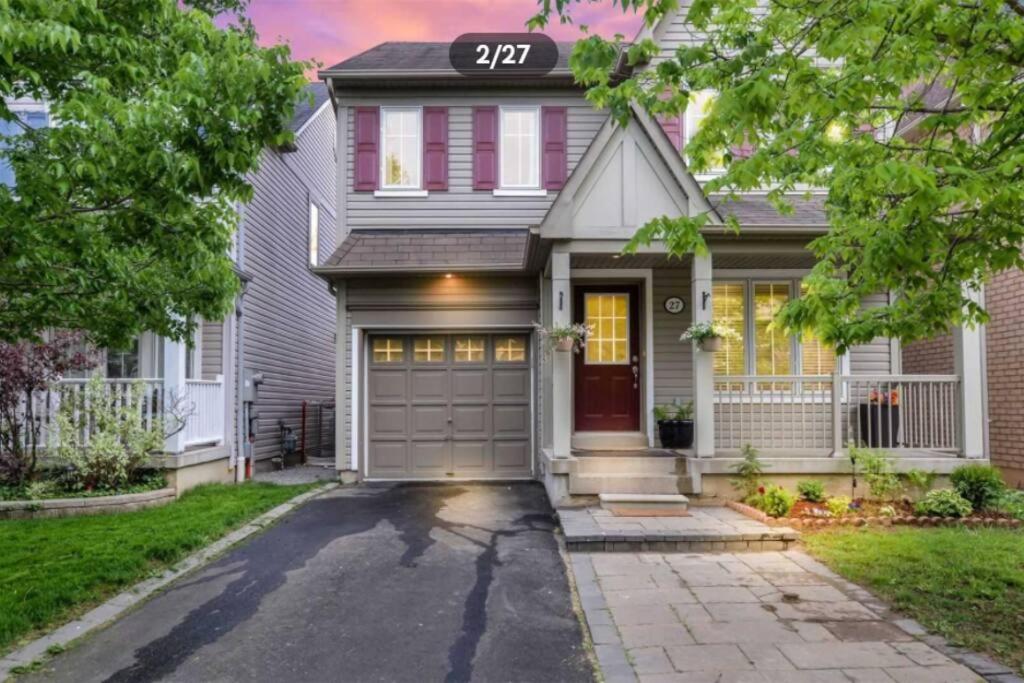 a house with a garage and a driveway at Entire 4 bed room detached residential home in Ajax