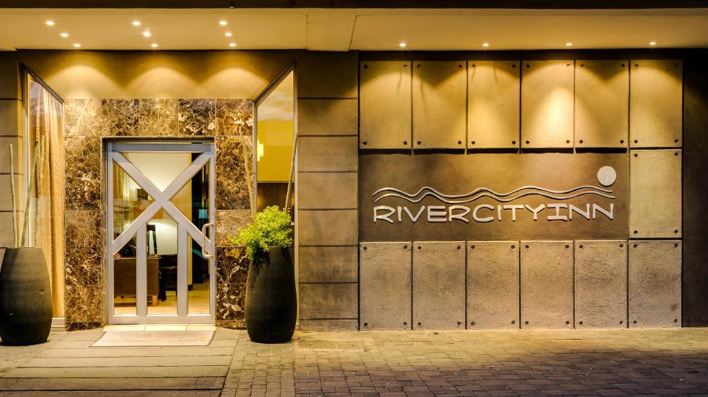 a building with a sign on the front of it at River City Inn in Upington