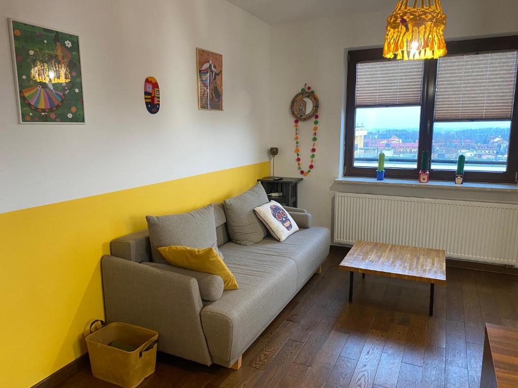 a living room with a couch and a table at Sunny Life Apartment in Warsaw