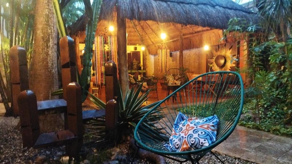 a green bench in front of a house at Barrio Latino al Centro by Pueblo Magico Network in Playa del Carmen