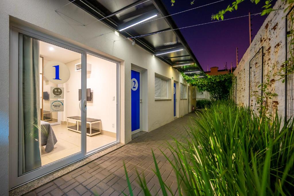 a corridor of an office building with a window at K2 Residence in Campinas