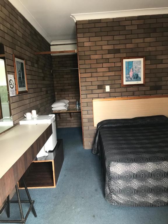 Postel nebo postele na pokoji v ubytování Downtown Motel