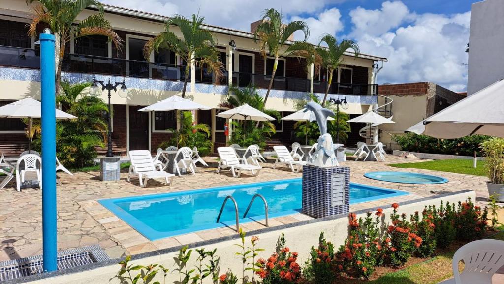 a hotel with a swimming pool and a resort at Flat do Golfinho in Tamandaré