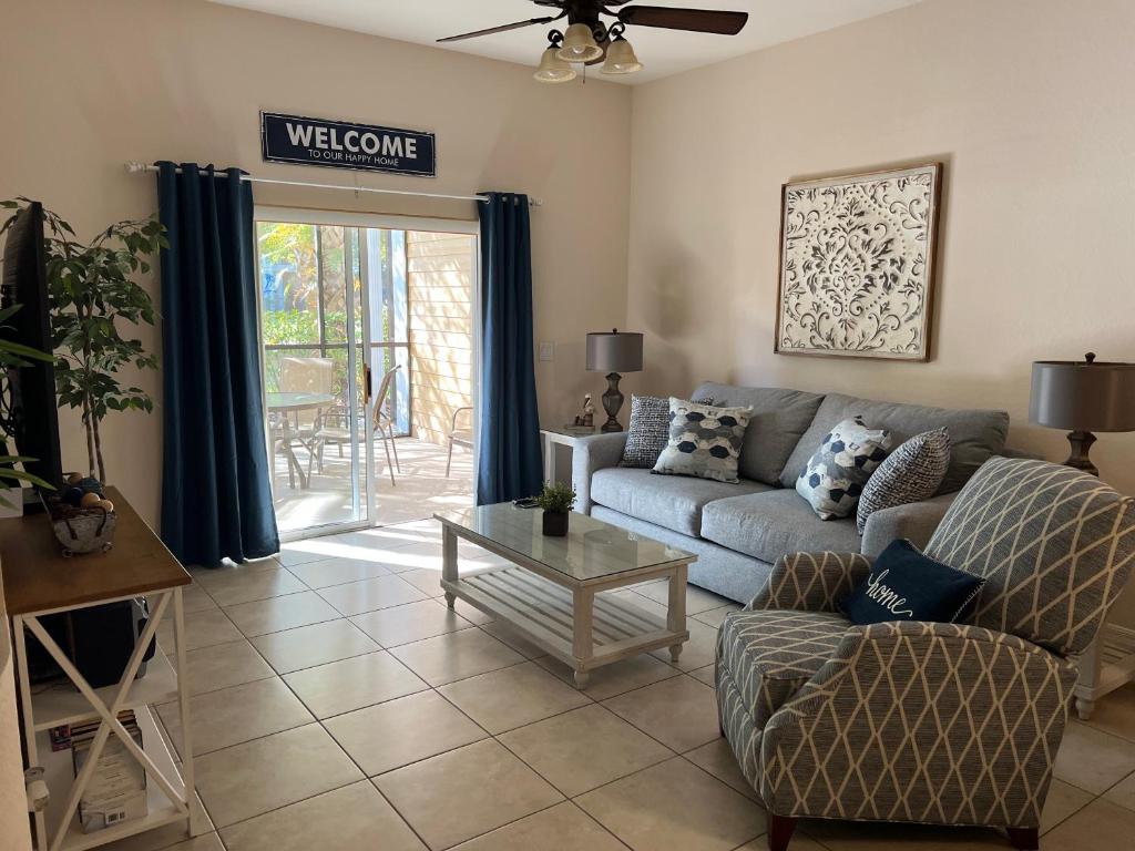 a living room with a couch and a table at BAHAMA BAY RESORT in Kissimmee