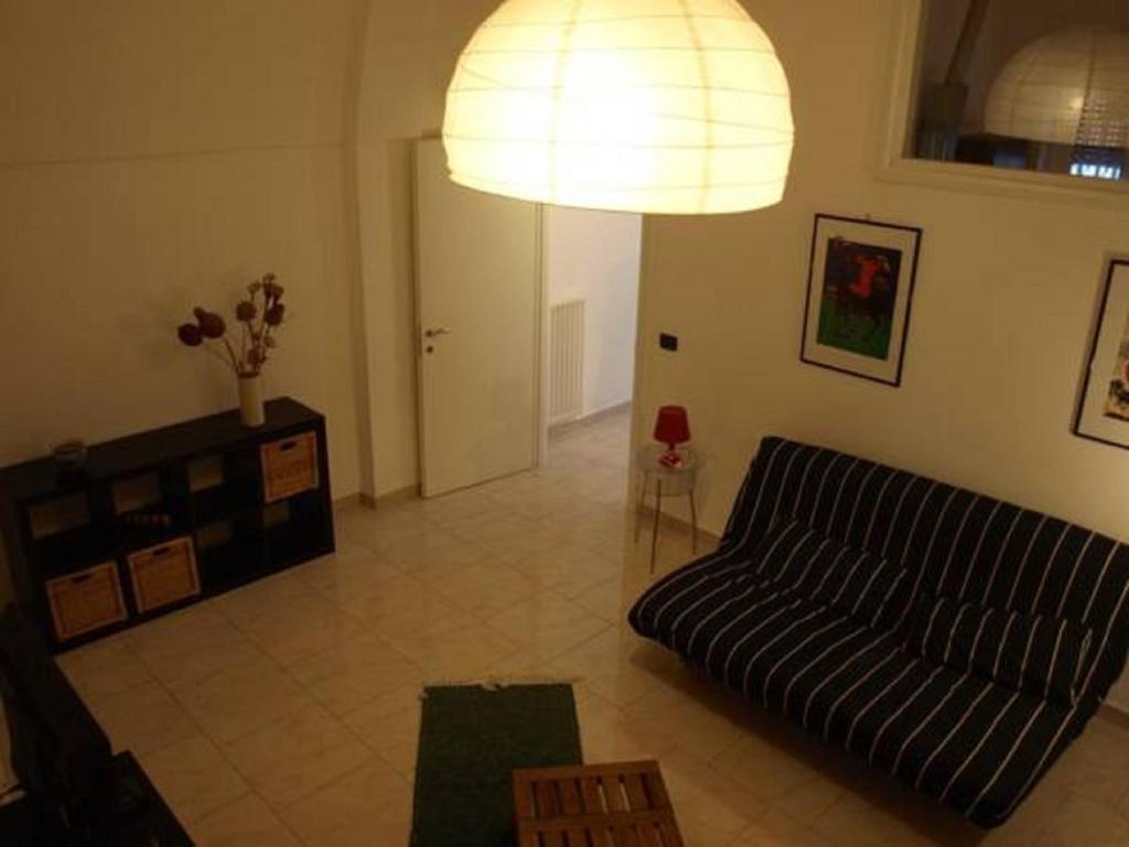 a living room with a couch and a lamp at Casa veneto in Montalbano Ionico