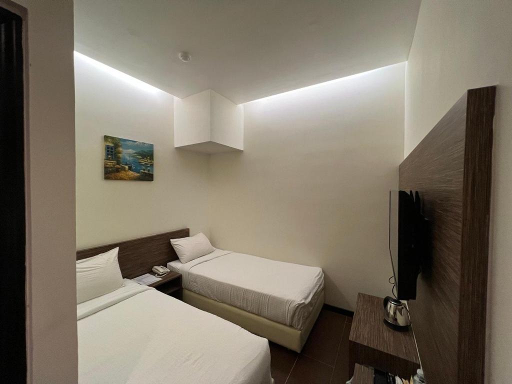 Postel nebo postele na pokoji v ubytování Nex Hotel Johor Bahru