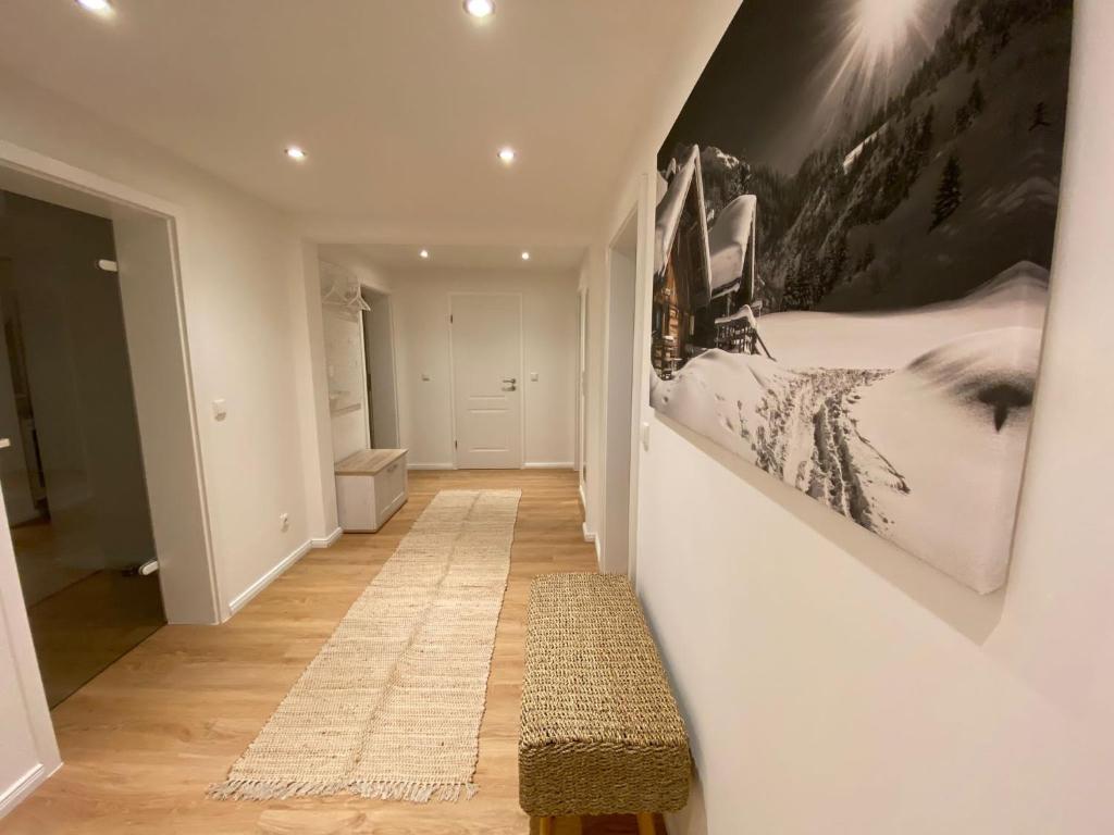 a hallway with a bench and a painting on the wall at Ferienwohnung Luxusblick in Bad Harzburg