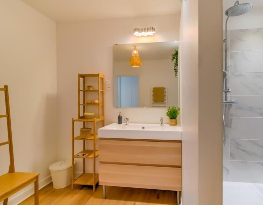 a bathroom with a white sink and a mirror at 2 bedroom apartment in the heart of Marseille in Marseille