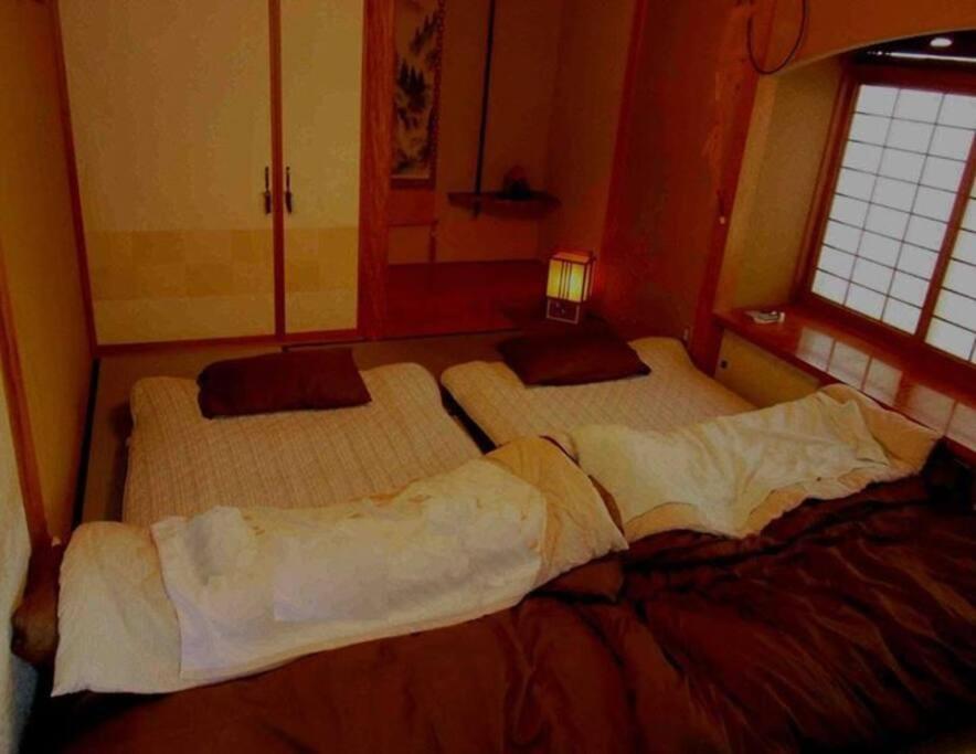 Postel nebo postele na pokoji v ubytování 一組限定の貸切空間 Guest House Engiya