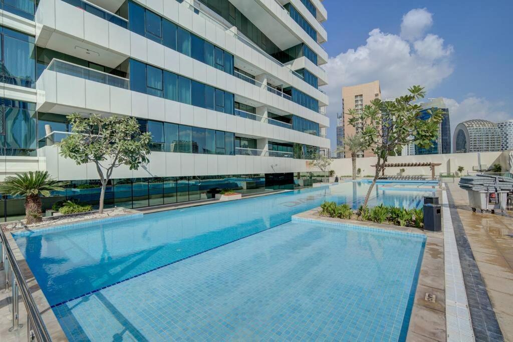 een zwembad voor een gebouw bij Luxurious studio Hotel Amenities in Dubai