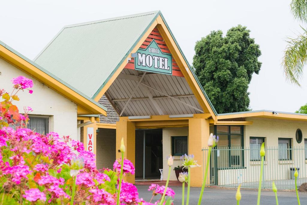 a motel with pink flowers in front of it at Echuca Motel in Echuca