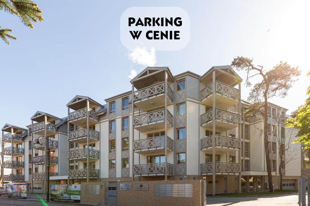 a rendering of a apartment building with the words parking w game at Rezydencja Park - City Apartments in Mielno