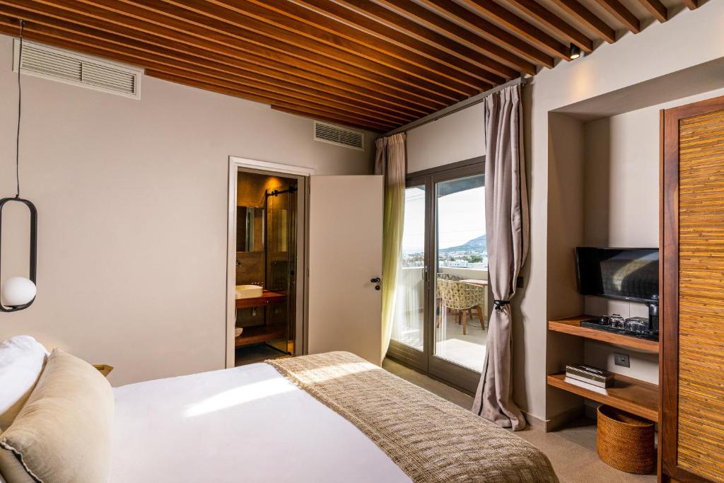 Postel nebo postele na pokoji v ubytování Uma Ray Suites