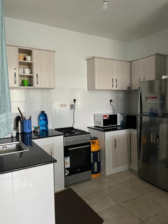 Kuchyň nebo kuchyňský kout v ubytování Zoe Homes 1br and 2br Apartment Greypoint 406