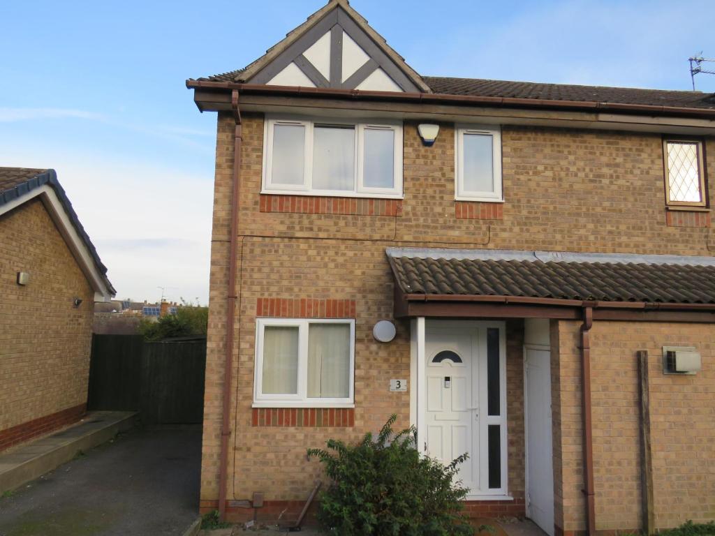 a brick house with a white door at Remarkable and perfect 3 Bed House in Nottingham in Nottingham