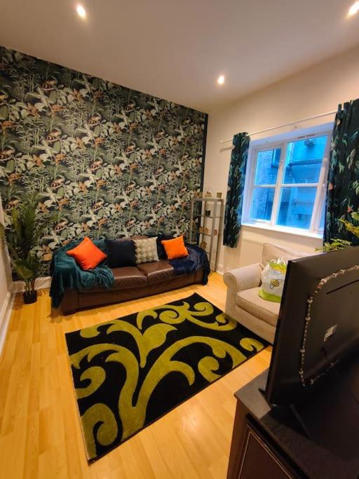 a living room with a couch and a rug at Newhall Apartment in Birmingham