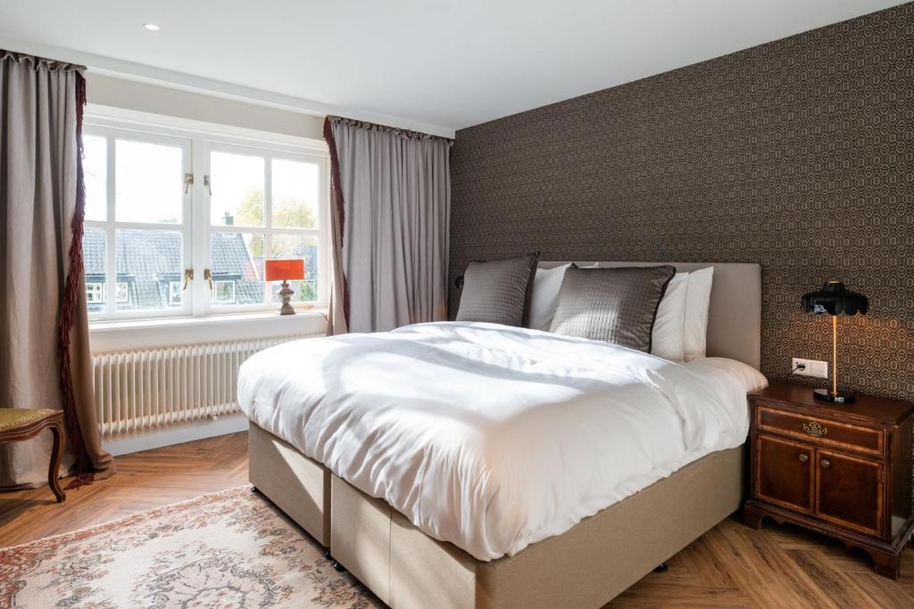 Postel nebo postele na pokoji v ubytování Boetiekhotel De Kastanjehof