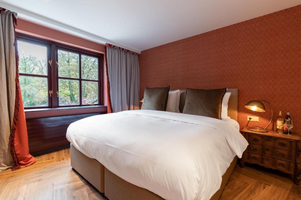 Postel nebo postele na pokoji v ubytování Boetiekhotel De Kastanjehof