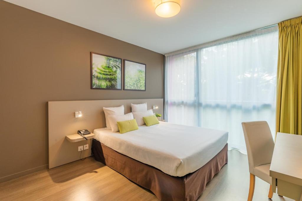 Ένα ή περισσότερα κρεβάτια σε δωμάτιο στο Appart’City Confort Rennes – Cesson Sévigné