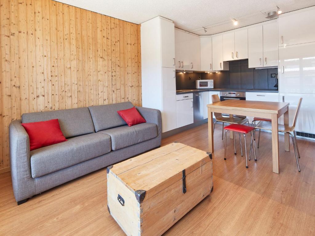 a living room with a couch and a table at Apartment Mirabeau by Interhome in Les Collons