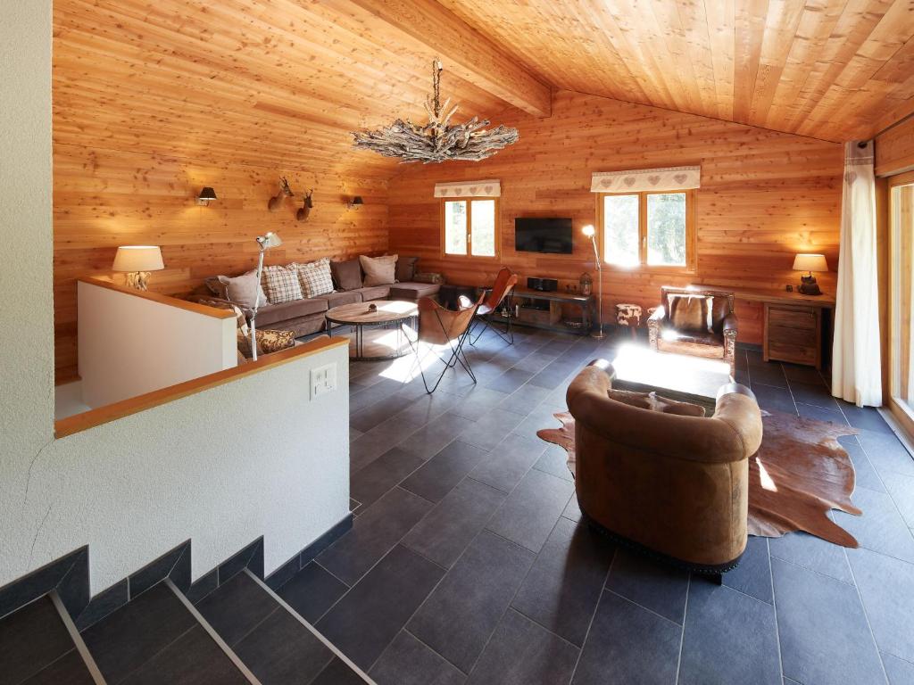 a living room with a couch and a table at Chalet Hiboux by Interhome in Les Collons