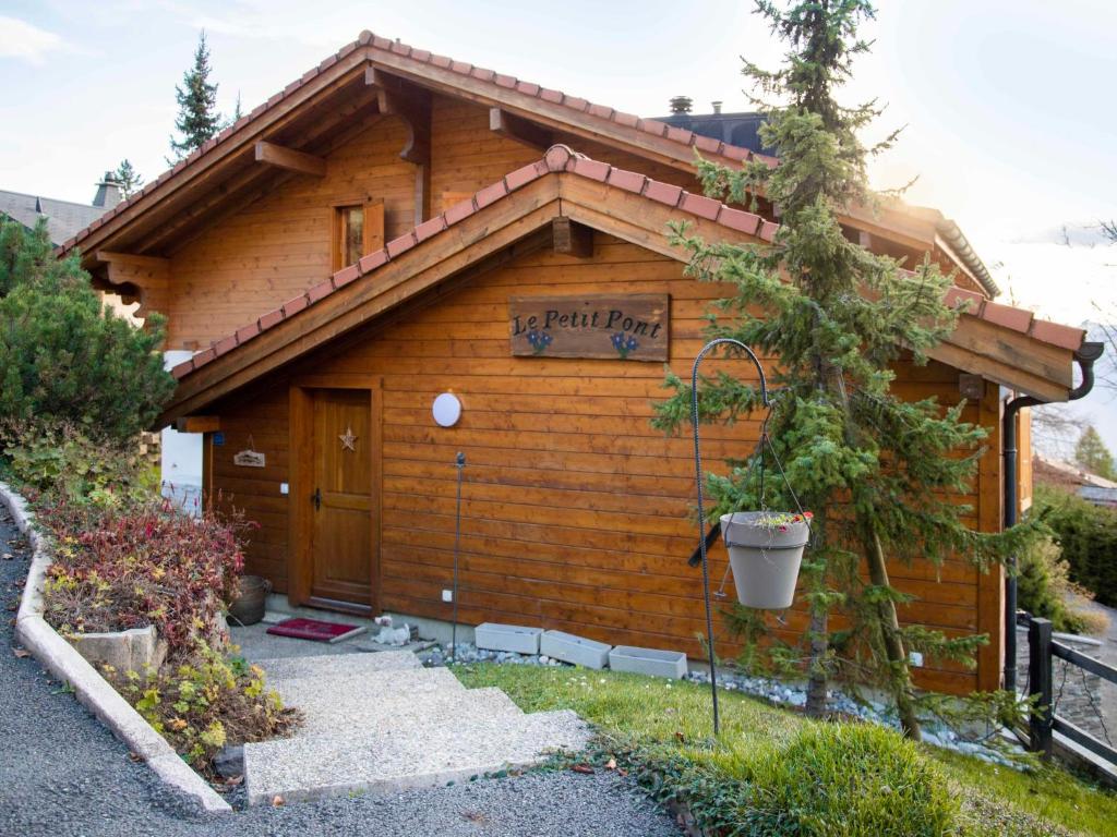 a log cabin with a sign on the side of it at Chalet Chalet Petit Pont by Interhome in Villars-sur-Ollon