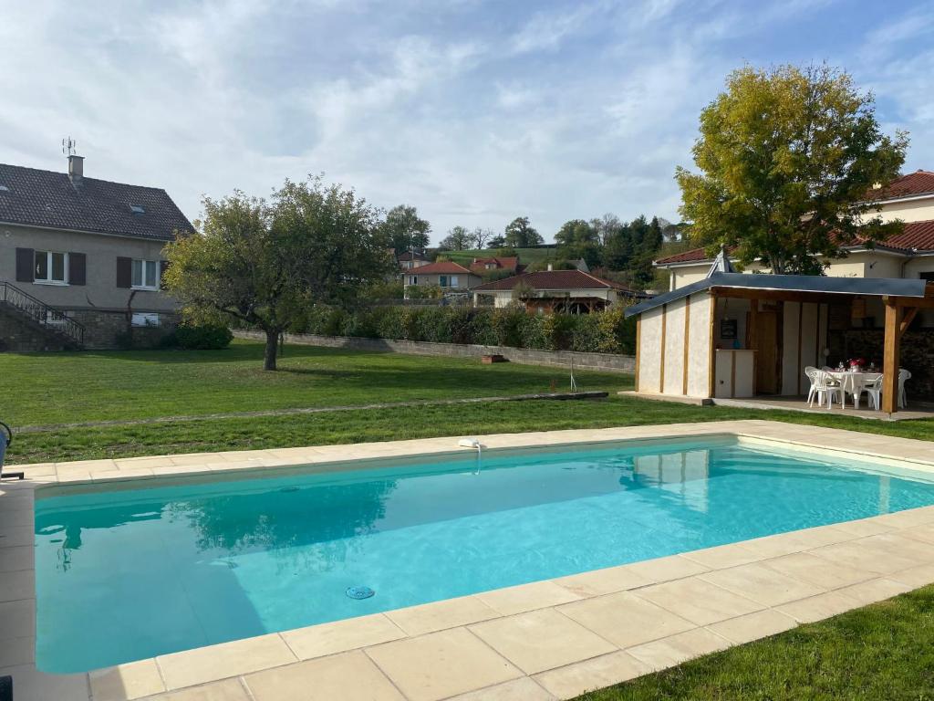 a large swimming pool in the yard of a house at Holiday Home Passerat by Interhome in Maurs