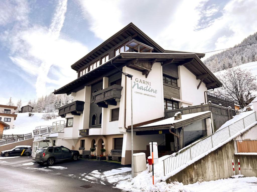 a building with a car parked in front of it at Apartment Nadine-8 by Interhome in Sölden