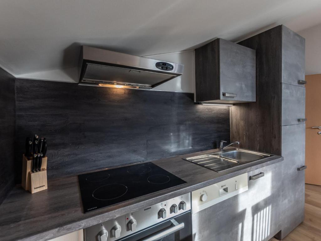 A kitchen or kitchenette at Apartment Alpenchalets-4 by Interhome