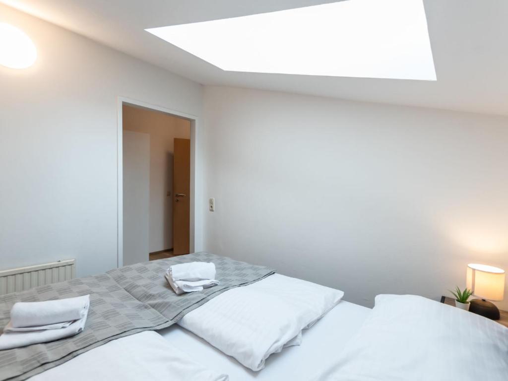A bed or beds in a room at Apartment Alpenchalets-4 by Interhome