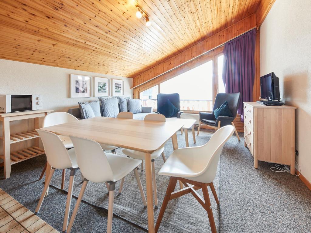 a room with a table and chairs and a couch at Apartment Le Hameau-7 by Interhome in Les Collons