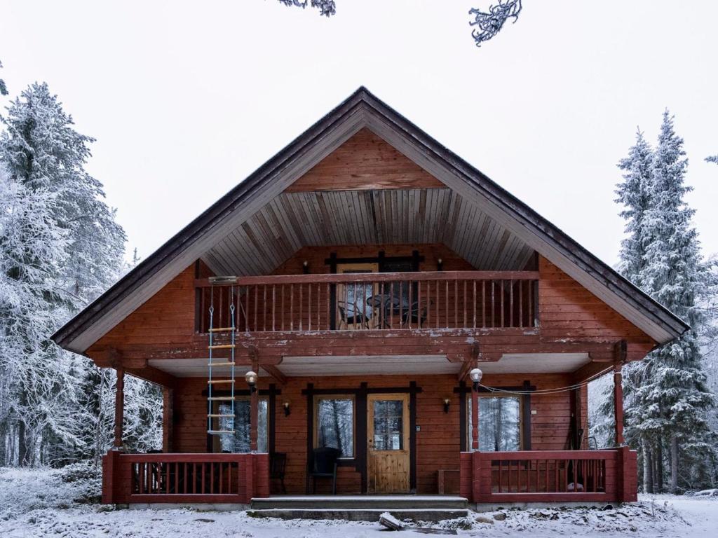 a log cabin in the woods in the snow at Holiday Home Hillakumpu by Interhome in Nissi