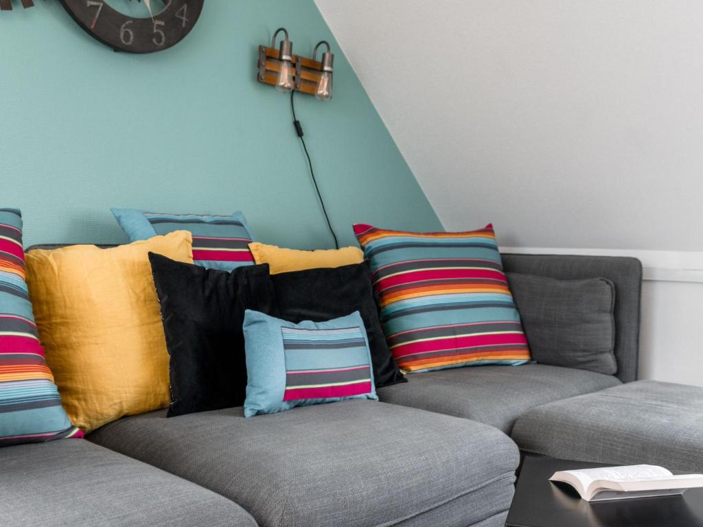 a living room with two couches with colorful pillows at Apartment Le Hoche-1 by Interhome in Quiberon