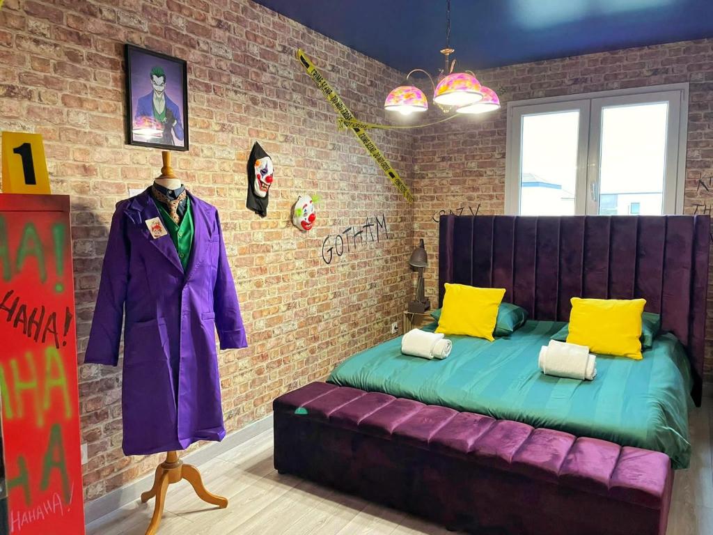 a bedroom with a purple bed in a brick wall at NEW - Bat'Appart - DIJON - Insolite in Longvic