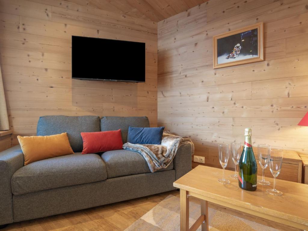 a living room with a couch and a table with wine glasses at Apartment Les Genepis-5 by Interhome in Tignes