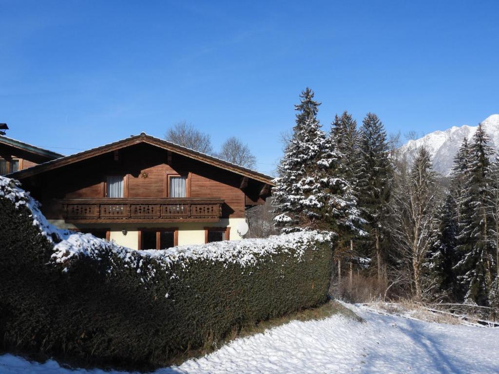 a snow covered house with a fence and trees at Holiday Home Haus Sigfried by Interhome in Bischofshofen