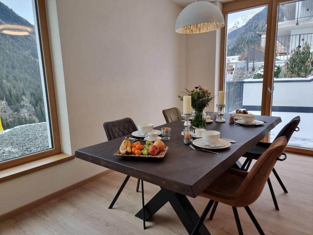 a dining room table with a bowl of fruit on it at Apartment Alpenschnucke Home by Interhome in See