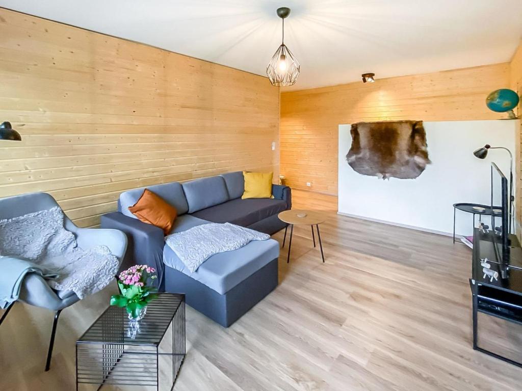 a living room with a couch and a tv at Holiday Home The cozy loggers suite by Interhome in Salla