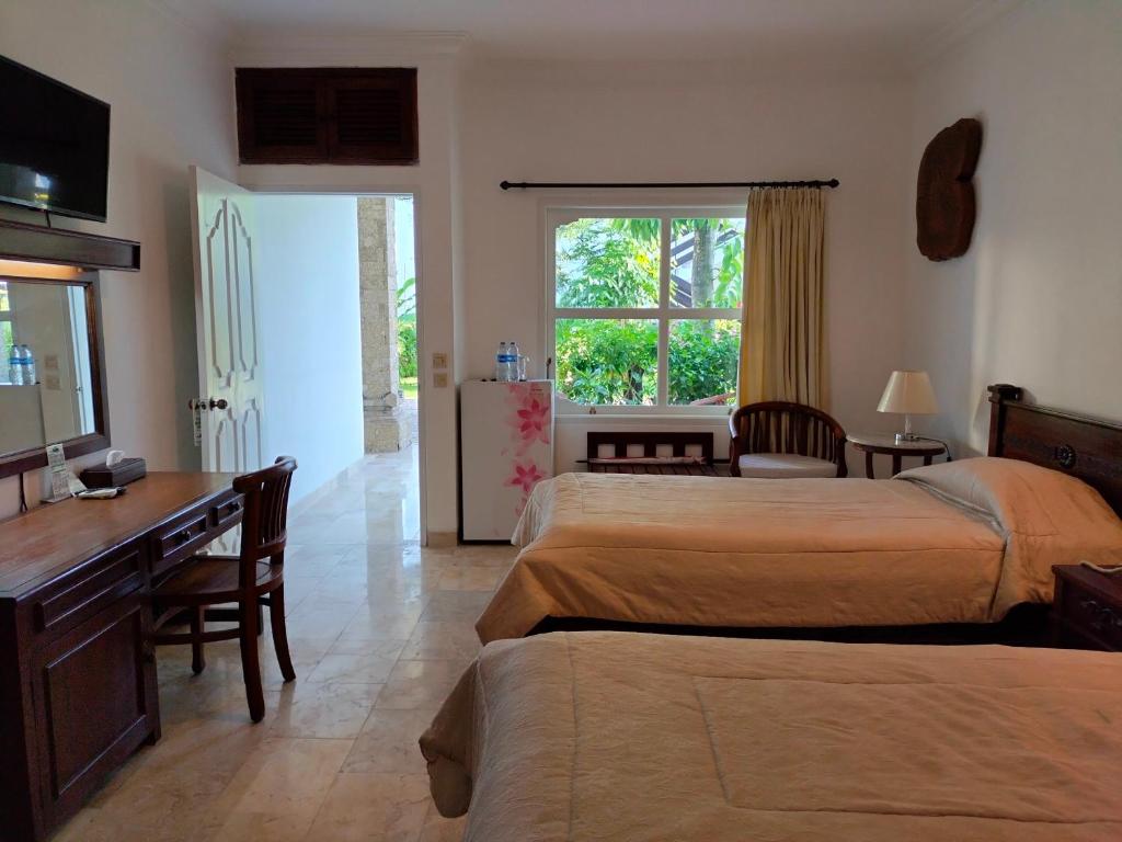 Postel nebo postele na pokoji v ubytování Grand Kumala Hotel - Hotel Kumala Legian Kuta Bali