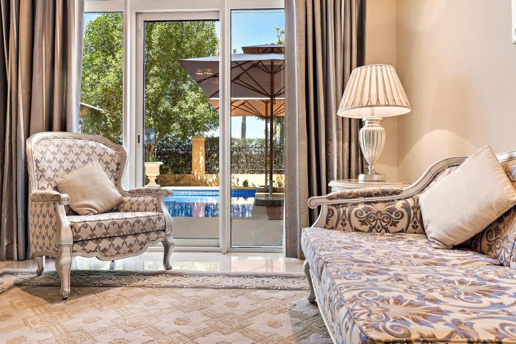a living room with a couch and a chair at Kempinski Hotel Palm Jumeirah in Dubai