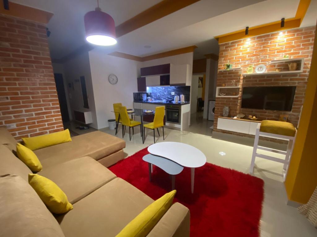 a living room with a couch and a table at Your Apartment in Pogradec