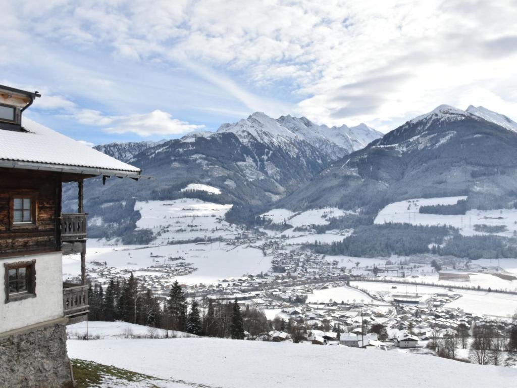 a view of a snowy mountain valley with a building at Apartment Appartment Wiesberg by Interhome in Niedernsill