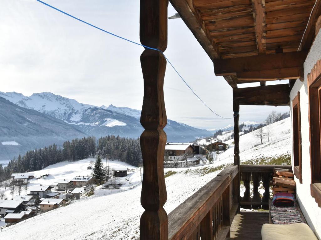 a view from the balcony of a cabin with snow covered mountains at Apartment Appartment Wiesberg by Interhome in Niedernsill