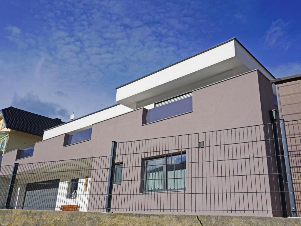 a house with a fence in front of it at Apartment FeWo Anna by Interhome in Fliess