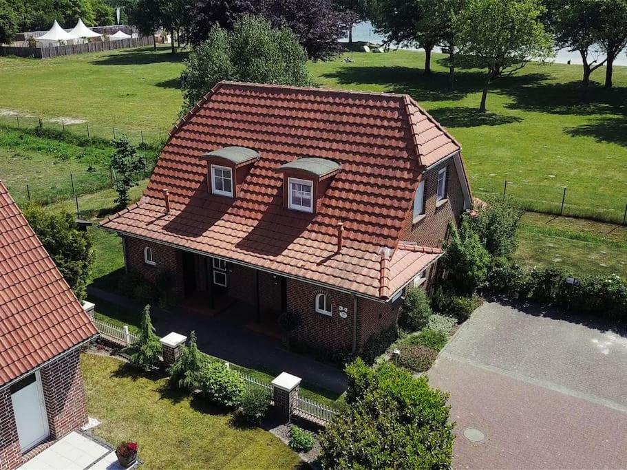 an overhead view of a house with a red roof at Ferienwohnung Lüttje Huck - Seeblick 2 in Aurich