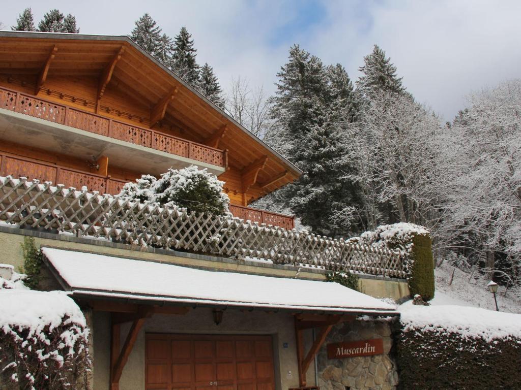 a house covered in snow with a fence at Apartment Muscardin 5-6 by Interhome in Chesières