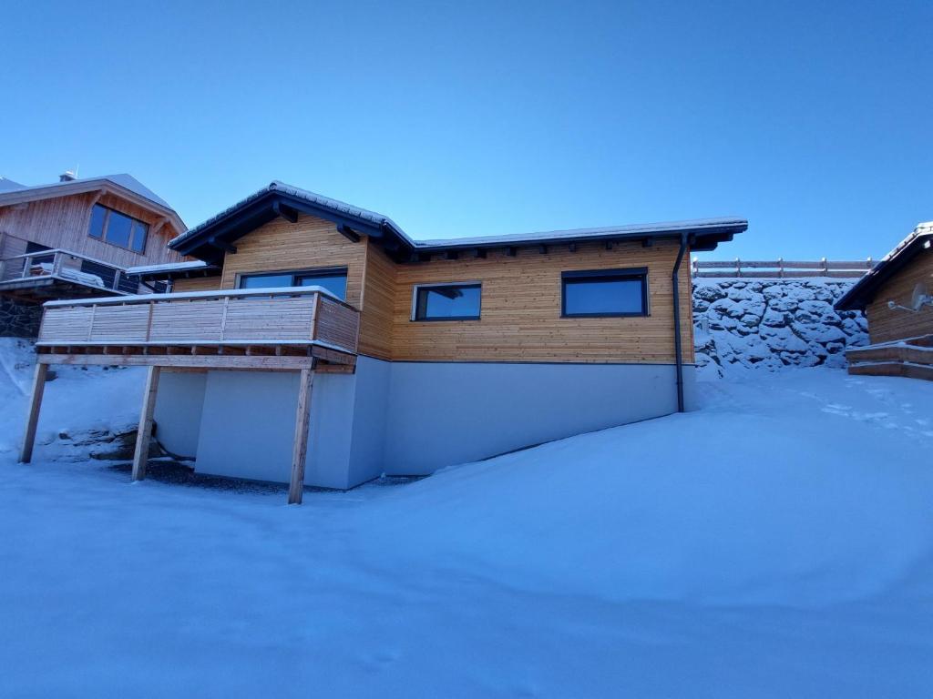 a house with a snow covered yard in front of it at Chalet Diamondsky by Interhome in Klippitztorl