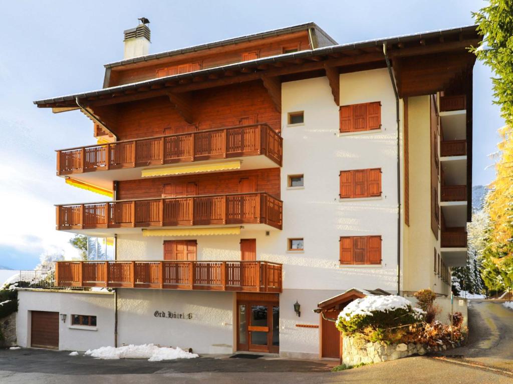 a large building with wooden balconies on it at Apartment Grand Hôtel B47 by Interhome in Villars-sur-Ollon