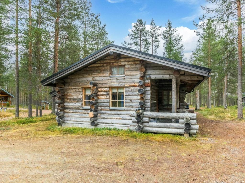 a log cabin in the middle of a forest at Holiday Home Kuopiokero by Interhome in Pyhätunturi
