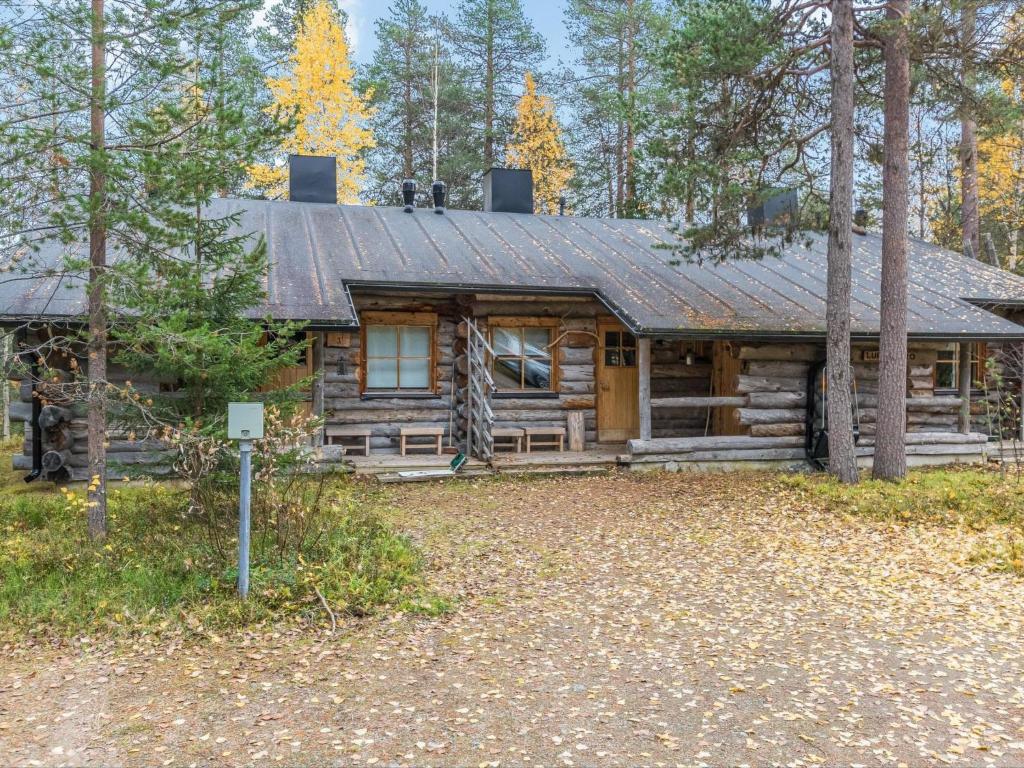 a log cabin in the woods with a yard at Holiday Home Luppokero 2 by Interhome in Pyhätunturi